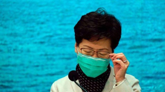 Hong Kong leader Carrie Lam wore a face mask to speak to the media (Reuters)