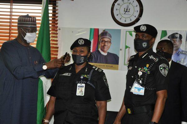 AIG Aishatu Abubakar (centre) being decorated with her new rank by SGF Boss Mustapha and IGP Mohammed Abubakar