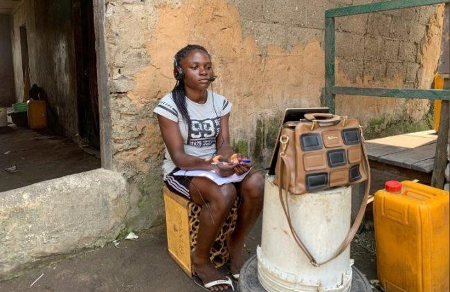 Esther Ikechukwu, a beneficiary of Slum2School project attends a virtual class from her hom