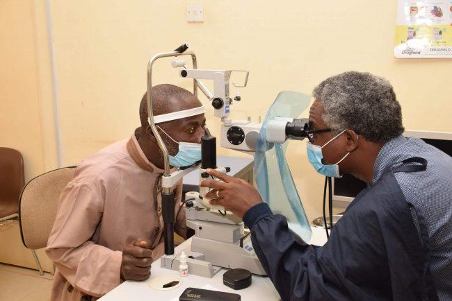 Dr Olusegun Olaniyi examies Mr Bello when the latter visited the Centre for follow-up