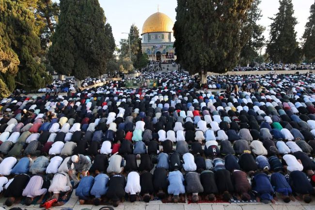 Palestinian worshippers attend Eid el-Fitr prayers at Al Aqsa Mosque