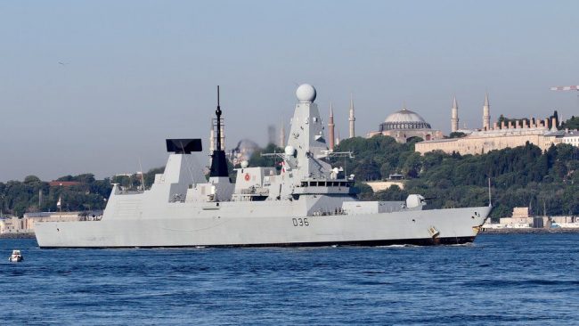 Russia says it fired warning shots at British warship, UK denies