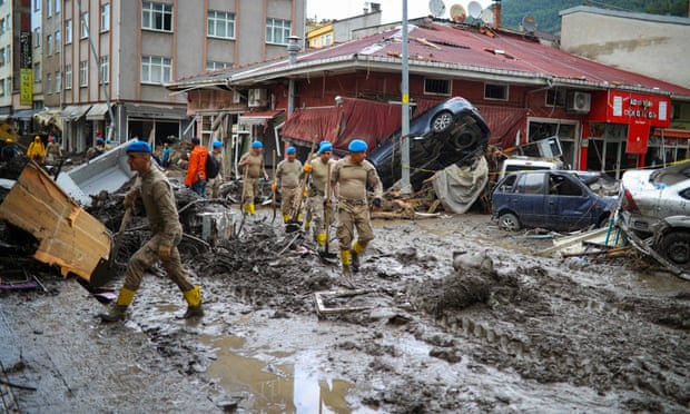 Soldiers arrive to clear the debris after the Ezine River broke its banks during flash floods in Bozkurt in the Black Sea region of Turkey. Photograph: AFP/Getty Images