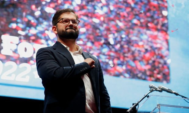 Chilean president-elect Gabriel Boric gestures to supporters in Santiago following his victory in the runoff presidential election. Photograph: Rodrigo Garrido/Reuters