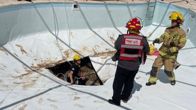Man killed as sink hole opens under swimming pool