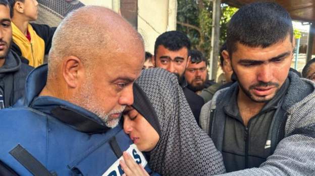 Al Jazeera's Wael al-Dahdouh hugs his daughter at the funeral of his son Hamza yesterday