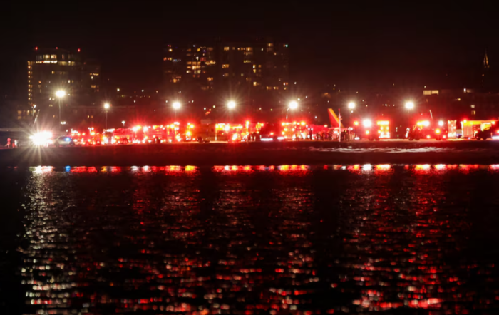 Emergency service vehicles stand near the site of the crash after American Eagle flight 5342 collided with a helicopter while approaching Reagan Washington National Airport and crashed in the Potomac River, outside Washington, U.S., January 29, 2025. REUTERS/Carlos Barria